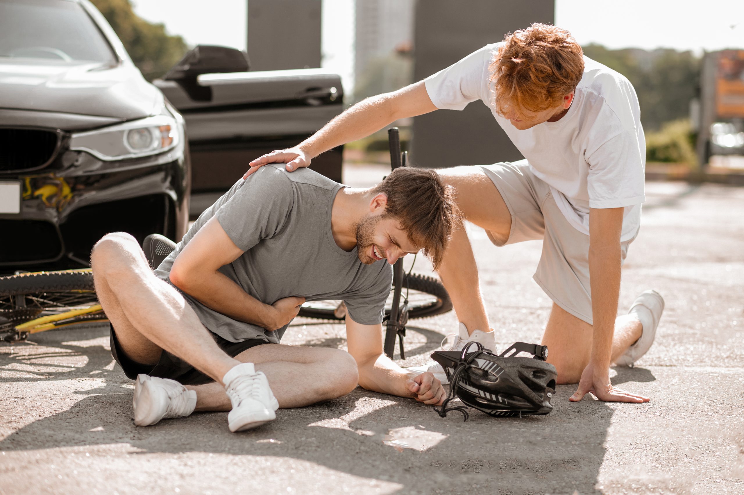 Unhappy injured cyclist and caring driver